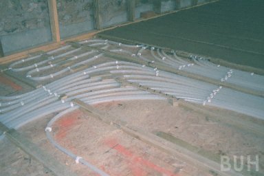 photo of partial infilling of pipes coming from underfloor heating manifold